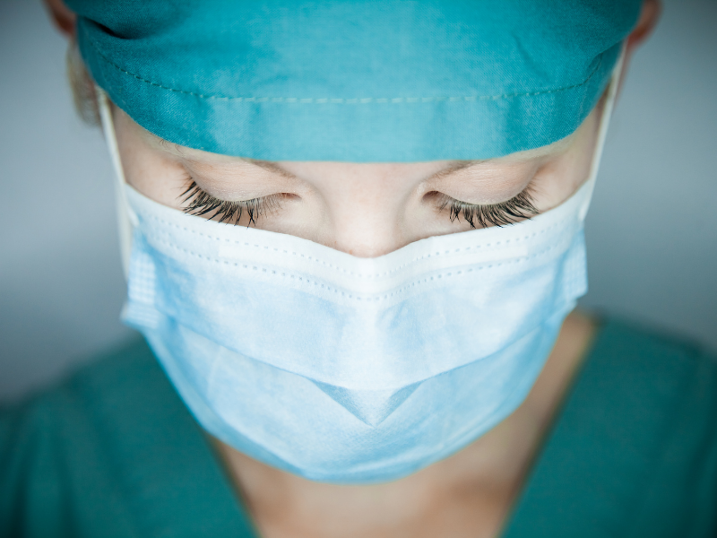 Nurse wearing a mask looking downwards